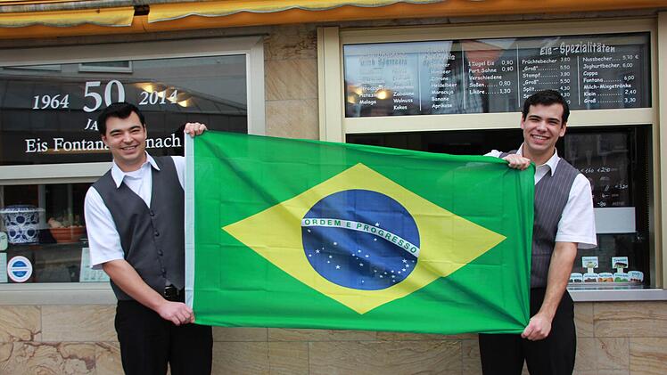 Die beiden Brüder Adriano und Dione Pedroso (von links) halten stolz die Flagge ihres Heimatlandes Brasilien hoch. Foto: Davina Zipfel