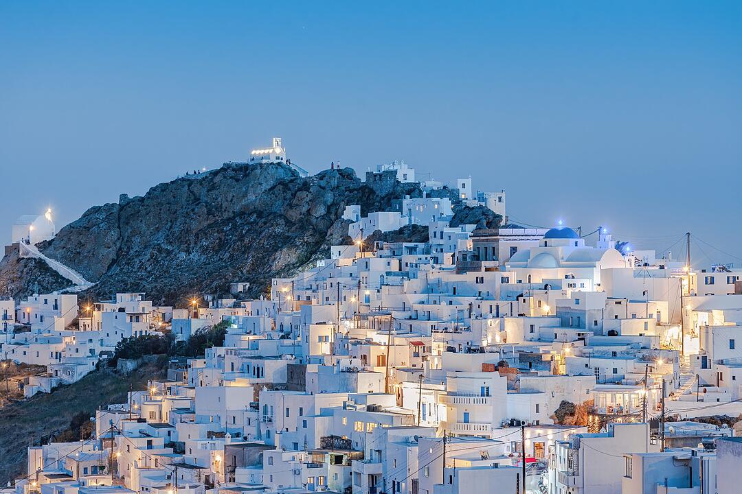 The chora - capital with traditional white houses of Serifos island Aegean Cyclades Greece against a blue sky during blue hour Die Chora - Hauptstadt mit traditionellen weißen Häusern der Ägäischen Kykladeninsel Serifos Griechenland vor blauem Himmel während der blauen Stunde