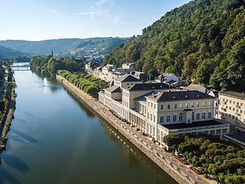 Blick auf die Lahn und die Uferpromenade im Bad Emser Kurviertel mit dem Kursaal-Gebäude rechts.