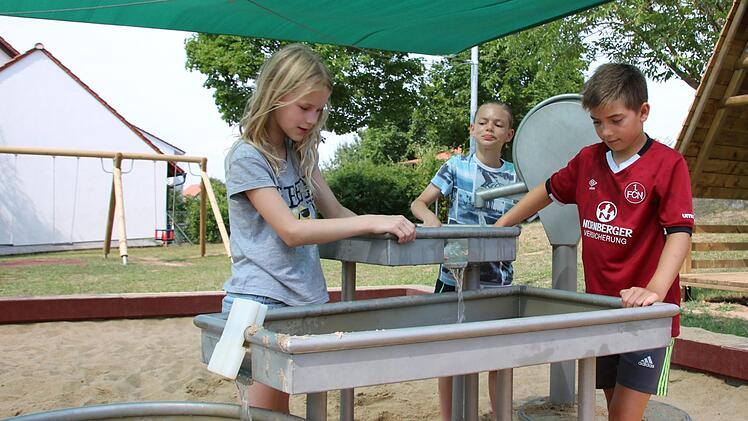 Die Spielplatz-Tester (von links) Elisabeth, Johann und David auf dem Spielplatz in der Nüdlinger Friedenstraße. Foto: Ralf Ruppert