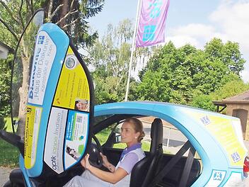 Julia Kania, die Pflegedienstleiterin der Diakoniestation Küps, hat viel Spaß beim Fahren des Elektro-Einsatzfahrzeugs.  Foto: hs