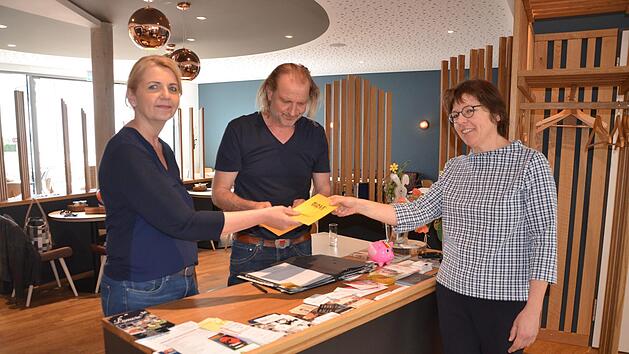 Gaby Richter und J&uuml;rgen Rattmann h&auml;ndigen einen Gutschein an Elke Bollmann aus.  Foto: Bernhard Panzer
