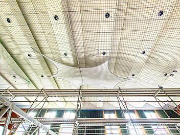 Die Decke der Stadthalle wird saniert. Die Arbeiten werden sich vermutlich &uuml;ber den ganzen August hinziehen. Ein gro&szlig;es Netz wurde eingesetzt, damit die Deckenteile nicht herunterfallen.  Foto: Anand Anders