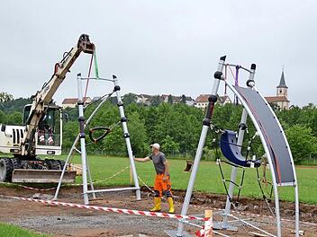 Zwei Mitarbeiter des gemeindlichen Bauhofs sind hier bei der Stellprobe des neuen Klettergerüstes. Sie hatten bereits eine entsprechende Grube auf dem Außengelände der Grundschule Premich ausgehoben und wollten die Fundamente anlegen. Doch daraus wurde vorerst nichts. Foto: Kathrin Kupka-Hahn