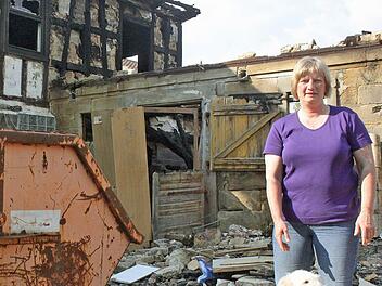 Beate Gürtler steht im Garten vor ihrem ehemaligen Wohnhaus. Der Brand vor zweieinhalb Wochen zerstörte das Zuhause ihrer Familie. Sie suchen nun eine neue Bleibe.  Fotos: Vanessa Schneider