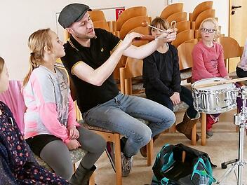 Interessiert lauschten die Kinder den Erklärungen des Schlagzeugers des Blasorchester Sand, Florian Rückert. Foto: Nadine Rippstein