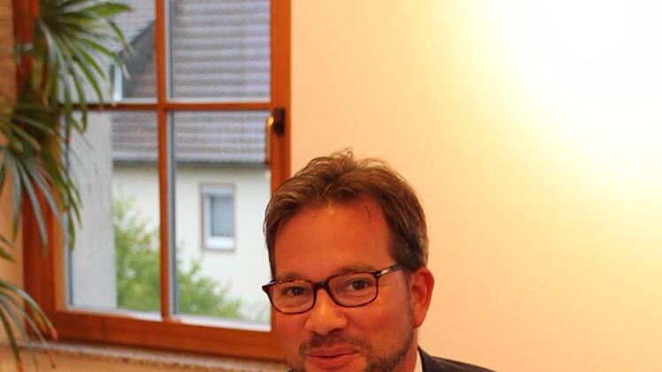 Staatssekretär Florian Pronold trägt sich ins Goldene Buch des Marktes Wildflecken ein. Foto: Ulrike Müller