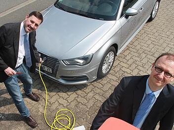 Pressesprecher Andreas Grosch (links) und Kreiskämmerer Holger Stingl laden die Batterie des neuen Hybridwagens des Landratsamtes an der Zapfsäule der Obermain-Therme in Bad Staffelstein wieder auf. Bis sie randvoll ist, dauert es rund zwei Stunden.  Foto: Andreas Schmitt