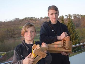 Die Brüder Alexander und Maxim Conze klappern in Zeiten der Corona-Krise vom Balkon aus. Zusammen mit vielen anderen Kindern aus Schondra übernehmen sie von Gründonnerstag Abend bis zur Osternacht den Dienst der Kirchenglocken. Foto: Horst Conze