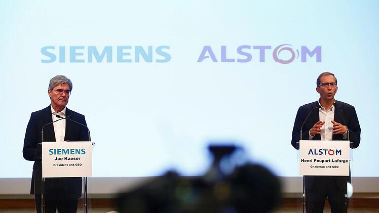 Der Geschäftsführer von Alstom, Henri Poupart-Lafarge (r), und der Geschäftsführer von Siemens Joe Kaeser  während einer Pressekonferenz  Foto: Thibault Camus/AP/dpa/Archiv