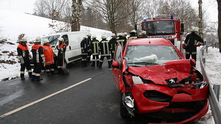 BLick auf die Unfallstelle mit dem total beschädigten Kleinwagen und dem Kleintransporter.