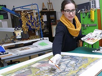 Kerstin Wittenburg bessert eine schadhafte Stelle an einem Gemälde von Georg Tappert aus.  Foto: Josef Hofbauer