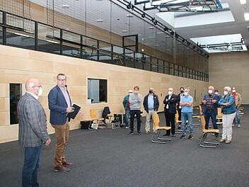 Bürgermeister Michael Kastl (links) und Bauleiter Mustafa Zecic (2.v.l.) luden die Stadträte und Gäste zu Beginn der Stadtratssitzung zu einem Rundgang durch die generalsanierte Mehrzweckhalle ein. Foto: Thomas Malz