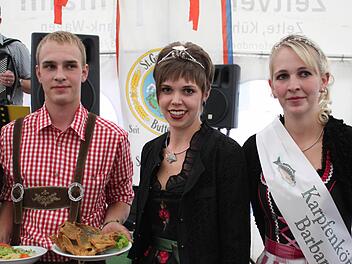 Lukas Jakob (links) präsentiert offiziell den ersten Aischgründer Spiegelkarpfen der Saison. Karpfenprinzession  Katrin I. und Karpfenkönigin  Barbara I. assistieren ihm bei seiner Aufgabe. Fotos: Sonja Werner