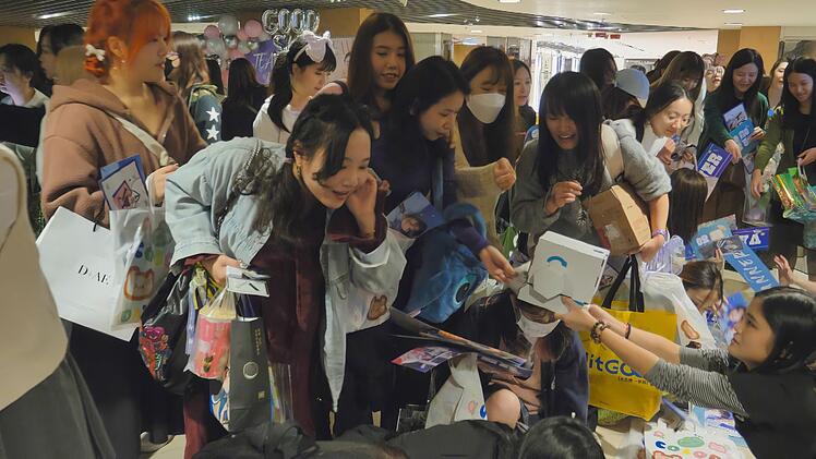 Auch in China ist K-Pop beliebt. Fans verteilen bei einem Konzert der Band VANNER in Hongkong kleine Geschenke wie Postkarten, Lollis oder Aufkleber.