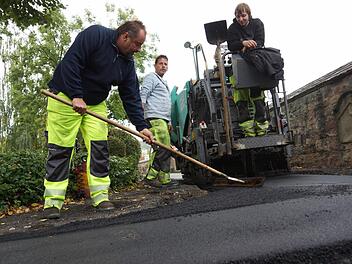 Arbeiter tragen die Deckschicht auf. Foto: Arkadius Guzy