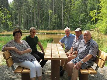 Lädt zum Verweilen ein: Die neue Sitzgruppe am Hurlacher See. (von links) Bürgermeisterin Patricia Schießer, Revierleiter Anton Goss, Erich Schießer (Vorsitzender OGV) Walter Zöller und Manfred Mußmächer, vom Rhönklub-Zweigverein Garitz testen sie schon mal.Doris Bauer