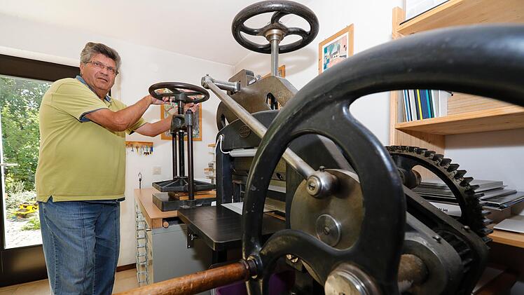 Hermann Ehreiser legt das fertige Buch in die Presse. Im Vordergrund die "alte Krause" zum Beschnitt der Buchkanten.  Foto: Matthias Hoch
