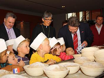 Regionalbischöfin Dorothea Greiner und der Präsident der Handwerkskammer, Thomas Zimmer, unterstützen Kulmbacher Kinder beim Backen des "Gott-sei-Dank-Brotes".  Foto: Geyer