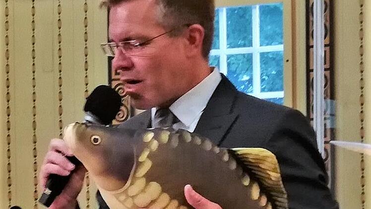 Musiklehrer und Posaunist Roman Riedel mit seinem Karpfen Kasimir. Foto: Sigismund von Dobschütz