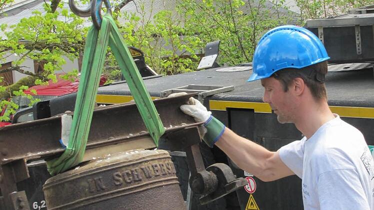 Thorsten Riedel von der Fa. Bayreuther Turmuhren vertäut die neuen Glocken, bevor sie von einem Kran auf den Seidmannsdorfer Kirchturm gehievt werden. Foto: Martin Koch