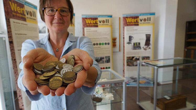 Birgit Speckle, beim Bezirk Unterfranken für Heimatpflege zuständig, nimmt eine Handvoll Brotmarken. Foto: Arkadius Guzy
