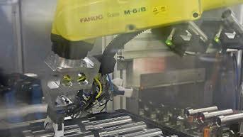 Ein Roboter bestückt die Waschanlage. Die Reinheit der Teile ist wichtig. Es geht um 1000stel Millimeter.