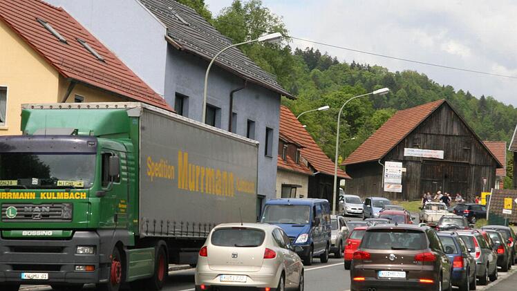 In Kauerndorf ging nichts mehr: Vier Autos und Traktoren hatten so seltsam am Straßenrand geparkt, dass der Verkehr nur noch einseitig fließen konnte - im Hintergrund lachten die Umgehungs-Aktivisten. Einige von ihnen wurden jetzt wegen Nötigung angezeigt. Fotos: Sonja Adam