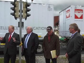 Hans Michelbach, Wilhelm Wenning, Jürgen Woll und Hendrik Dressel (von links) diskutieren vor einem vorbeirasenden Lkw über den Zustand der Bundesstraße 303 bei Oberelldorf im Landkreis Coburg.