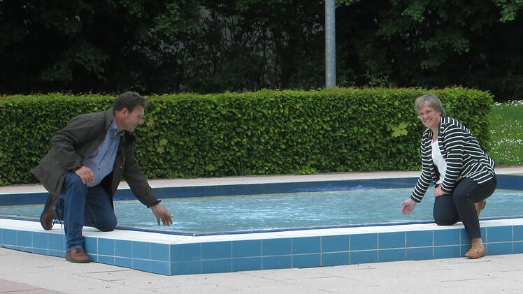 Bäderbetriebsleiter Edgar Beck (l.) und die Geschäftsführerin der Stadtwerke, Anja Binder (r.) beim Temperaturtest am Kinderbecken.