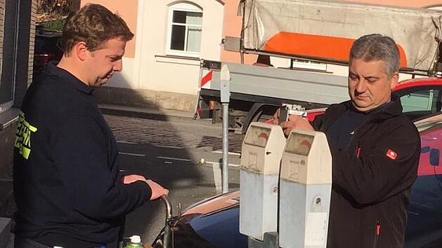 Ein letztes Mal werden diese Parkuhren vom k&uuml;nftigen Zweiten Ger&auml;tewart Ricardo Ciolka und Ger&auml;tewart Horst Sch&uuml;tz (beide Feuerwehr Kronach) geleert. Foto: Stefan Wicklein