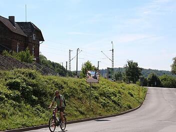 Noch führt am Creidlitzer Fabrikweg die Straße hinauf zum Bahnübergang. 2016 soll hier eine Unterführung gebaut werden.  Foto: Simone Bastian