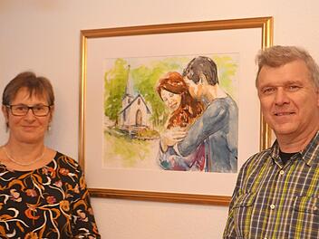 Die Künstlerin Gertrud Gerlach präsentiert dem Ramsthaler Bürgermeister Alfred Gündling das in Aquarelltechnik gemalte Bild im Trauzimmer, welches ein Liebespaar vor der Ramsthaler Marienkapelle darstellt. Foto: Andreas Lomb