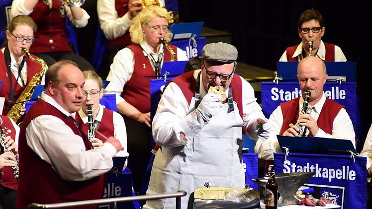 Humoristische Einlagen gehören dazu. Hier kann sich Dirigent Thomas Besand nur wundern: Roland Jonak macht Brotzeit auf offener Bühne.Stephan Herbert Fuchs
