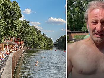 Menschen entspannen sich an der Hainbadestelle in Bamberg. Rechts ist ein Mann, der ein Video &uuml;ber seinen Besuch macht.