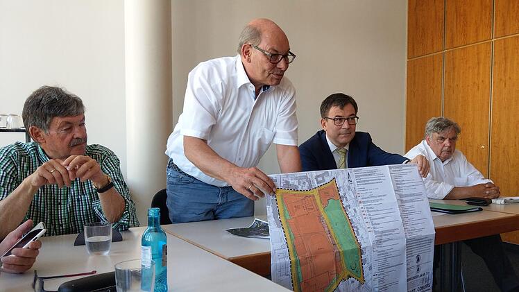 ans-Heinrich Ulmann und Christian Müller (sitzend) zeigen den Bebauungsplan 7/11 für Anger und Rosengarten. Links Hans Weberpals, rechts Gerhard Amend. Foto: Simone Bastian