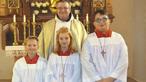 Die neuen Ministranten (von links) Benjamin Stapf, Julia Müller und Sebastian Reis mit Pater Christoph Potemka  Foto: Klaus-Peter Wulf