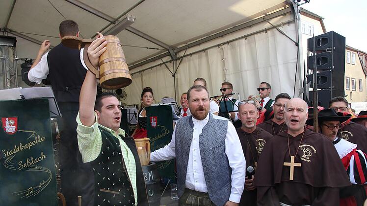 Es ist geschafft: Bürgermeister Maximilian Neeb hat das Bierfass angestochen, sein Vorgänger Martin Mittag (Mitte) hat ihn dabei unterstützt. Jetzt kann der Probeschluck genossen werden. Foto: Michael Stelzner