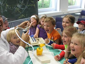 Im Inneren einer Paprika: Dr. Matthias Blanke, leitender Oberarzt an der Unfallchirurgie der Uni-Klinik Erlangen, zeigt den Besuchern des St.-Mauritius-Kindergartens in  Röttenbach, welche spannenden Dinge man mit einem Endoskop entdecken kann. Fotos: bau