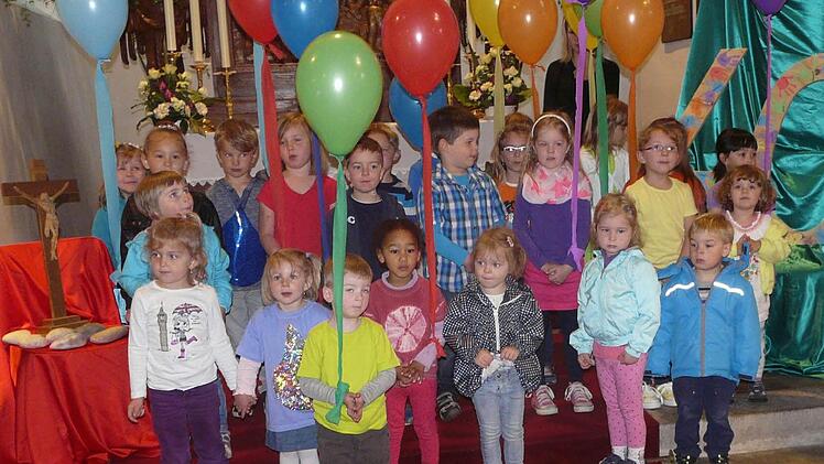 Mit bunten Luftballons feiern die Kinder in der Kirche.  Foto: Pöhlmann