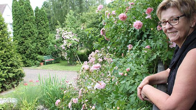Hildegard B&ouml;hm genie&szlig;t den Blick vom Balkon aus auf all die bl&uuml;henden Rosen in ihrem Garten. Fotos: Popp