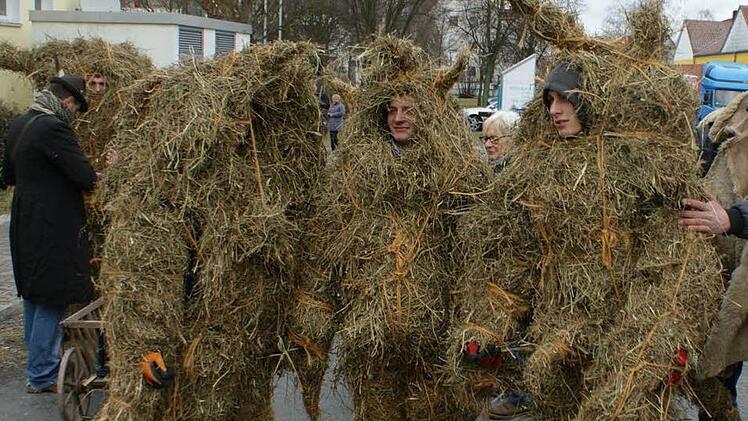 Die sogenannten Fasalecken müssen unverheiratete Burschen sein. Bis zu vier Stunden dauert es, bis das Stroh den Körper komplett umhüllt. Dann kann der Umzug beginnen. Foto: privat