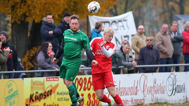 Es hat lange gedauert, bis die Partie des FC Kronach gegen den SV Neuses Fahrt aufnahm. Die Spieler auf dem Feld gaben trotzdem alles, wie hier im Kopfballduell zwischen dem Neuseser Michael M&uuml;ller (gr&uuml;nes Trikot) und Marc Schulz.  Foto: Heinrich Wei&szlig;