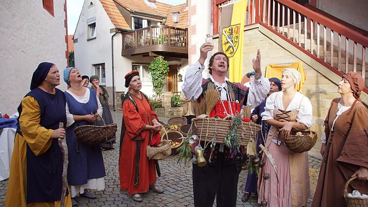 Marktleben in Zeil auf dem Weg zur Stadterhebung: Maria Egglseder (links) von der Stettfelder Theaterbühne übernahm die Gestaltung dieser Szene. Julia Melchior (2. von rechts) schlug als Zeiler Aktive in Stettfeld die Brücke zu den dortigen erfahrenen Theaterleuten. Im Mittelpunkt der Szene hier David Krüger als Reliquienhändler.Sabine Weinbeer
