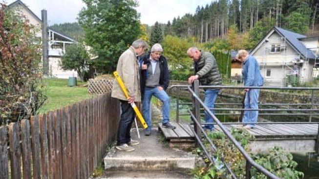 Das Bild zeigt (von links) VdK-Lotse Günter Bauer, Vorsitzenden  Wolfgang Förtsch, seinen Stellvertreter Roland Freund und  Frauenbeauftragte Anneliese Munzer am sogenannten "Stadelmanns-Wehr".- An den beiden Aufgängen zum Steg sollte geprüft werden, ob beiderseits eine Rampe angelegt werden kann. Die Handläufe müssen gut fassbar und stabil sein.     Tristan Förtsch