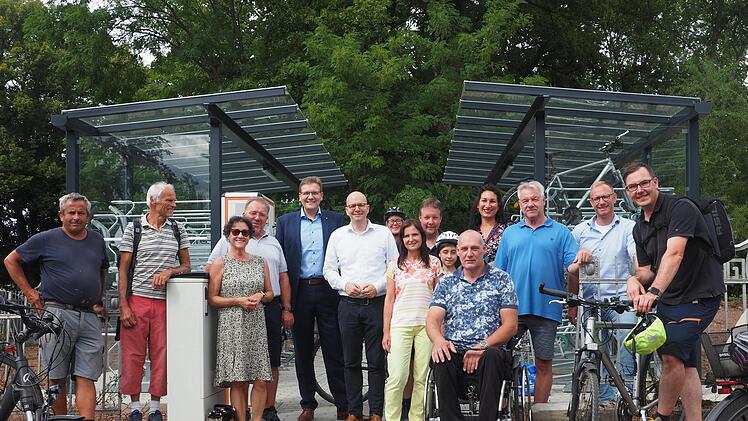 Oberbürgermeister  Dirk Vogel (6. v. l.) gibt im Beisein einer Delegation des Stadtrats die neue Fahrradparkanlage am Kissinger Bahnhof zur Nutzung frei. Foto: Mario Selzer