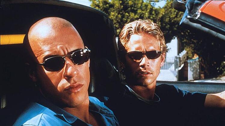 Mit "The Fast and the Furious" startete vor 25 eine der erfolgereichsten Actionreihen des Kinos. Einen wichtigen Anteil am Erfolg hatte neben Hauptdarsteller Vin Diesel (links) auch Paul Walker, der dem Auftaktfilm einen ersten kreativen Ansto&szlig; gab.