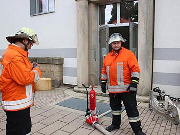Die Feuerwehrmänner Stefan Wicklein (links) und Christian Reuß am Einsatzort, dem Nebeneingang der Lucas-Cranach-Schule.  Foto: Friedwald Schedel