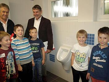 Bei der Besichtigung der neuen Schultoiletten sind alle begeistert. Links Rektor Wilfried Holzmann, rechts Bürgermeister Gerhard Wunder mit Schülern aus der zweiten Klasse. Foto: Susanne Deuerling