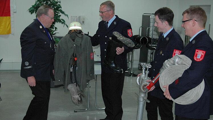 Abschied vom langjährigen Kommandanten: Georg Fuchs (links) wird von den Kameraden der Werkfeuerwehr Paul & Co, Hubert Simon, Robin Kirchner und Jens Peter für den Ruhestand ausgerüstet. Fuchs wurde außerdem zum Ehrenkommandanten ernannt. Foto: Sebastian Schmitt-Mathea